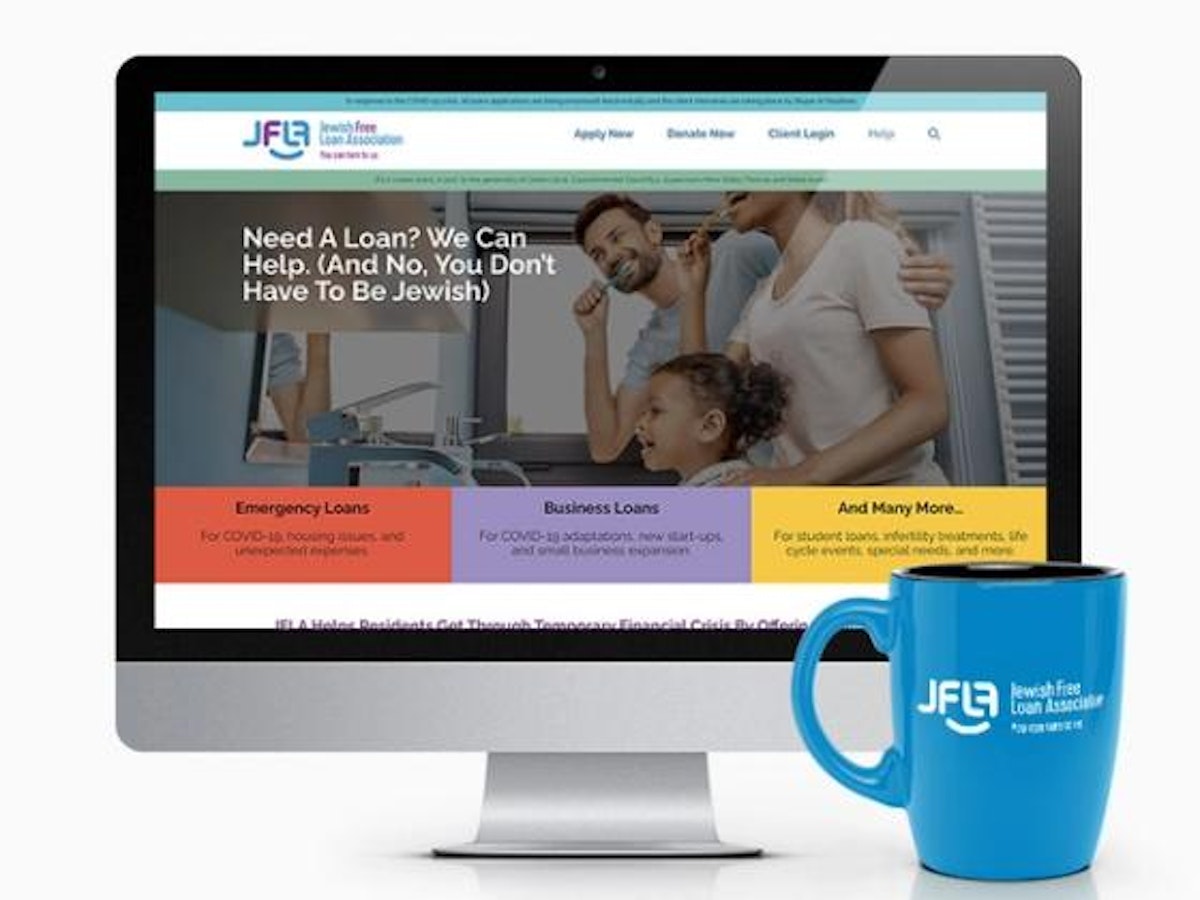 Blue coffee mug in front of computer screen showing new JFLA home page